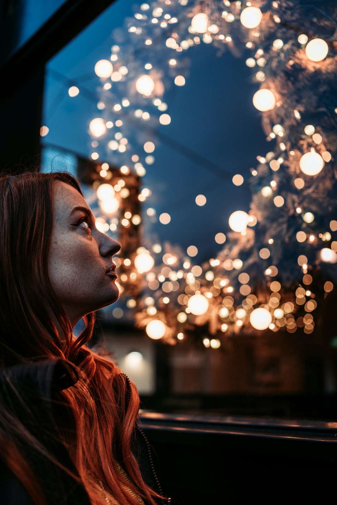 woman in red leather jacket looking at the lights