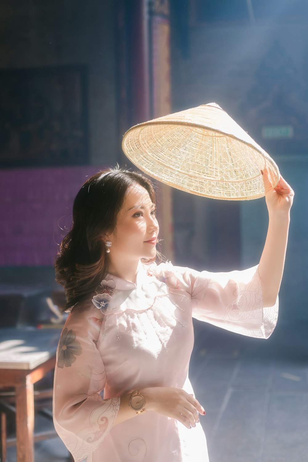 woman in white long sleeve shirt holding white hand fan