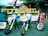 Three motorcycles are parked in front of a rustic shop with a sign reading 'Hale'iwa Bottle Shop'. The bikes display numbers and logos, with the central bike being predominantly white, the left one featuring a mix of blue and yellow, and the right one primarily red. A wooden sign advertising craft beer and wine is positioned to the left. The scene is set in an outdoor market area with a casual, laid-back atmosphere.