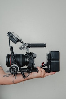 black video camera on black tripod