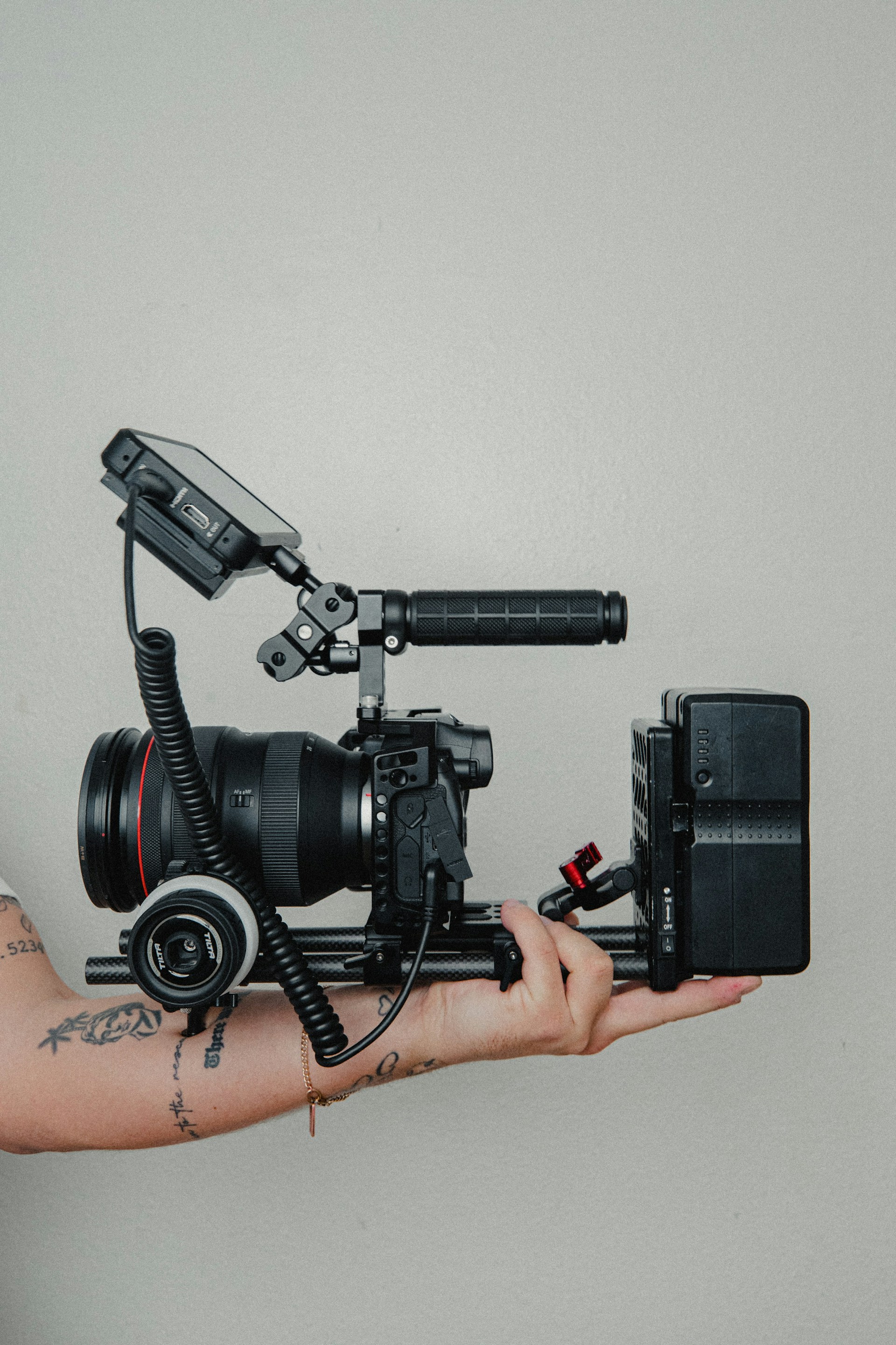 black video camera on black tripod