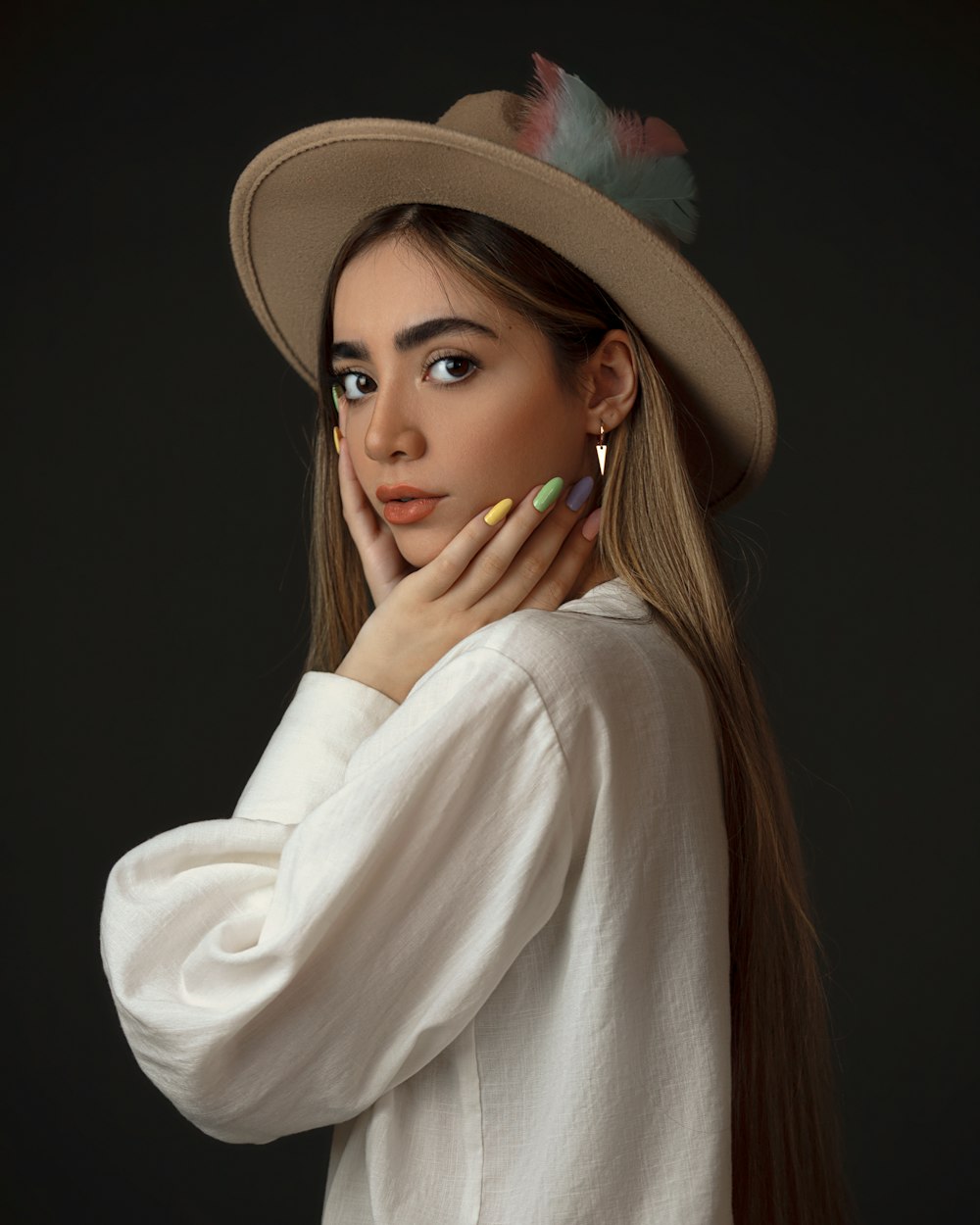 woman in white long sleeve shirt wearing brown hat