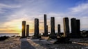 brown concrete pillars on body of water during daytime