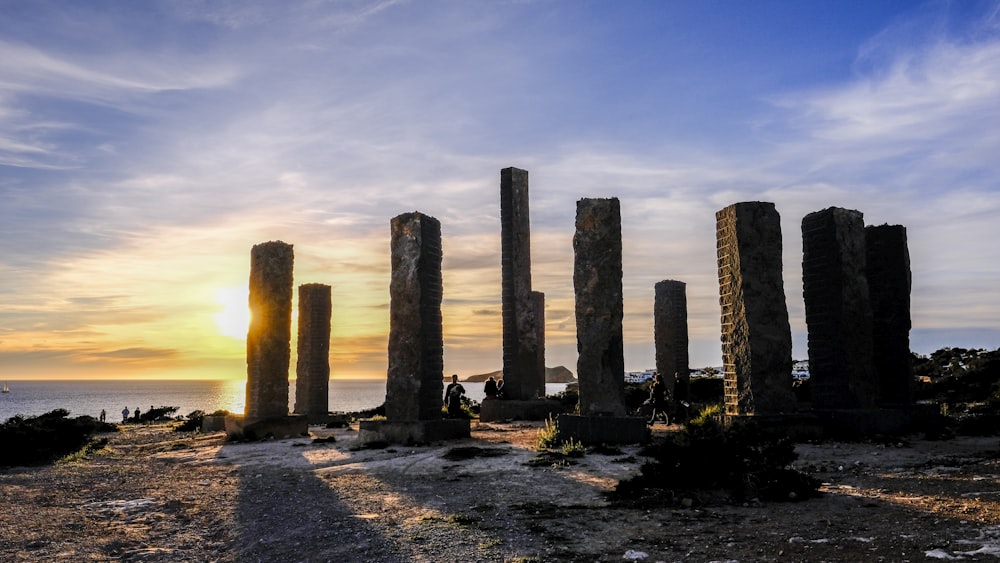 brown concrete pillars on body of water during daytime