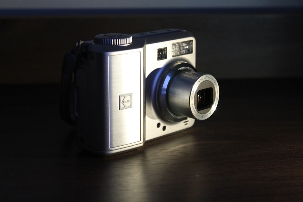 black and silver camera on brown wooden table