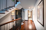 brown wooden staircase with white wooden door