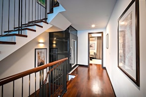 brown wooden staircase with white wooden door