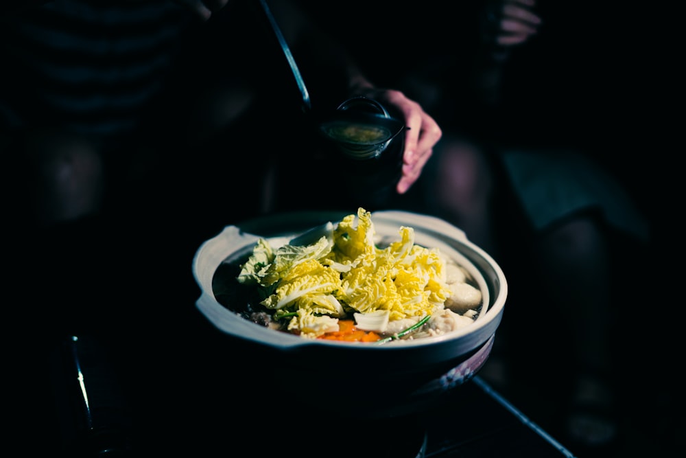 person holding stainless steel spoon and fork