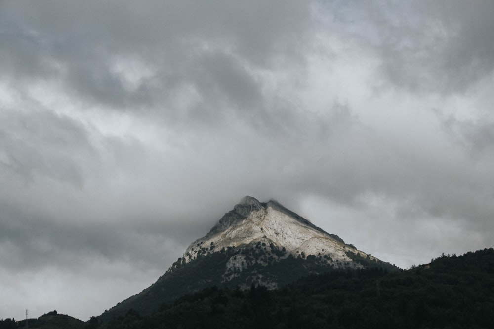 green mountain under white clouds during daytime