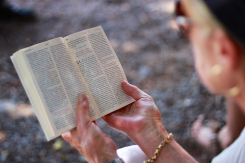 person holding book during daytime