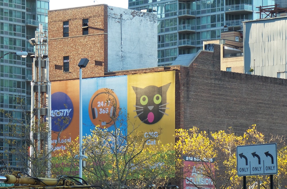 brown concrete building with yellow and blue wall graffiti