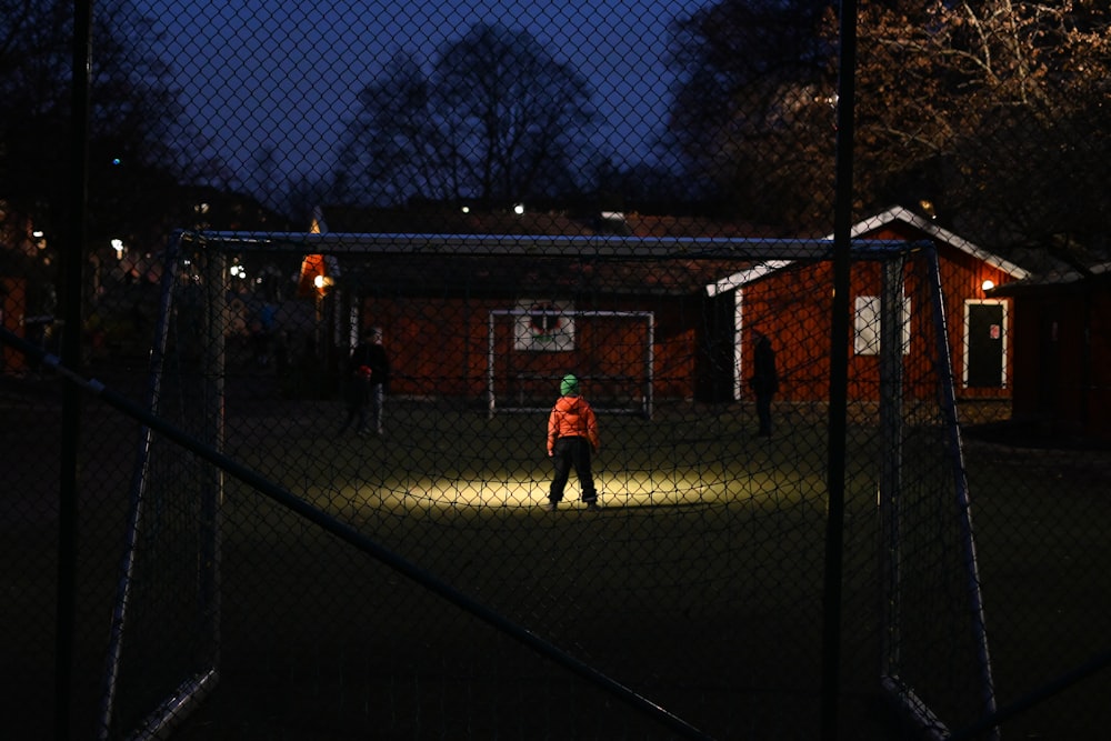 people standing on green grass field during night time