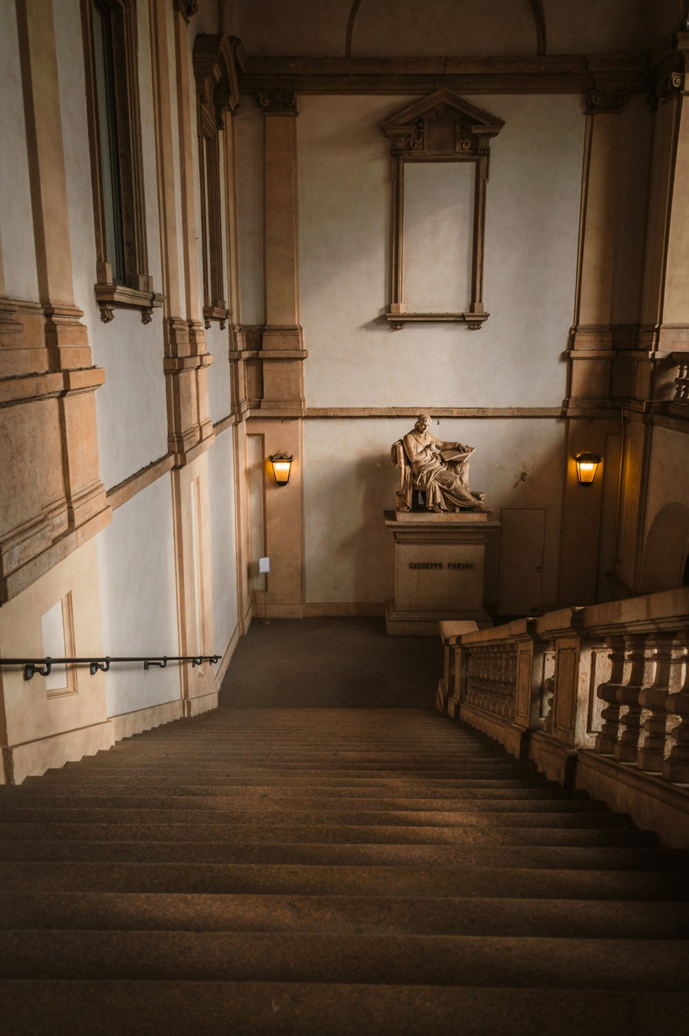 brown wooden staircase in white concrete building