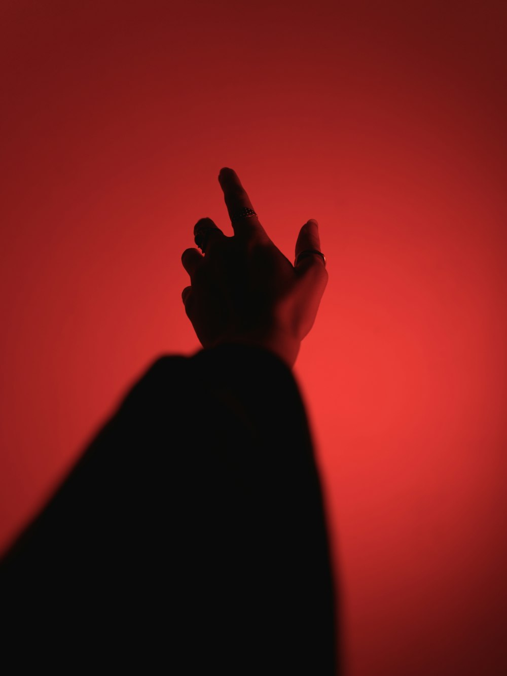 silhouette of person raising right hand