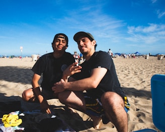 man in black crew neck t-shirt sitting beside man in black crew neck t-shirt