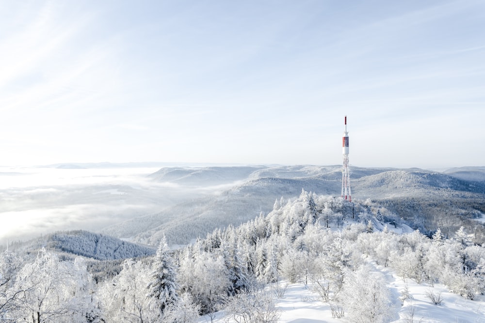 white and red tower on snow covered ground