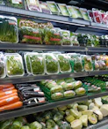 Workers carefully packing vegetables in a clean, modern facility preparing for export.