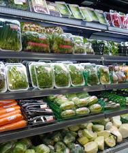 Fresh green vegetables neatly arranged for export packaging.