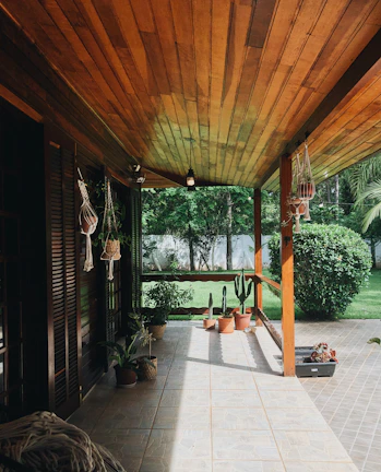 A cozy backyard patio surrounded by well-maintained shrubs and colorful plants.
