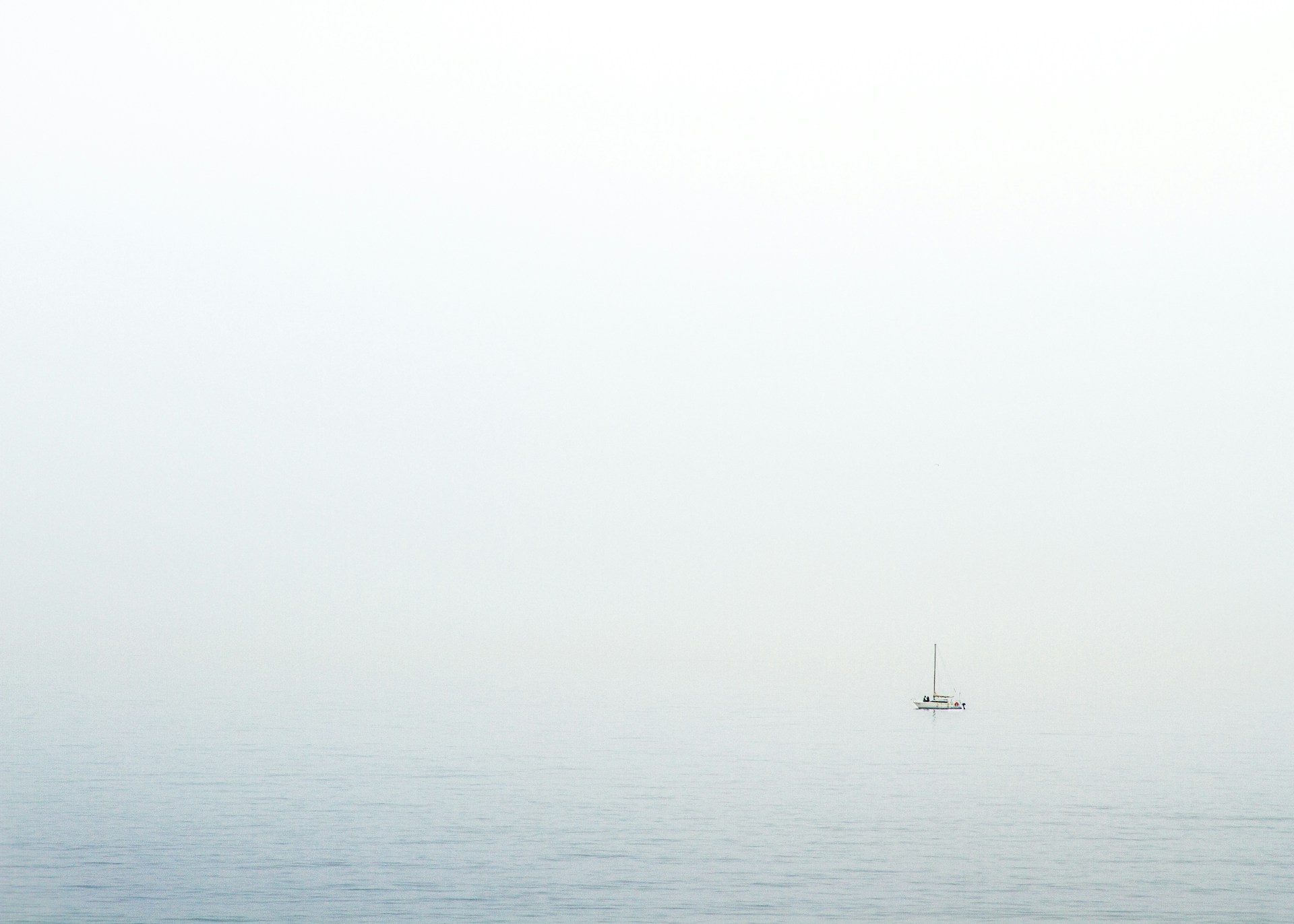 body of water under white sky during daytime