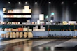 Warm-lit shelf featuring pet supplies next to neat, modern digital gadgets in pastel colors.