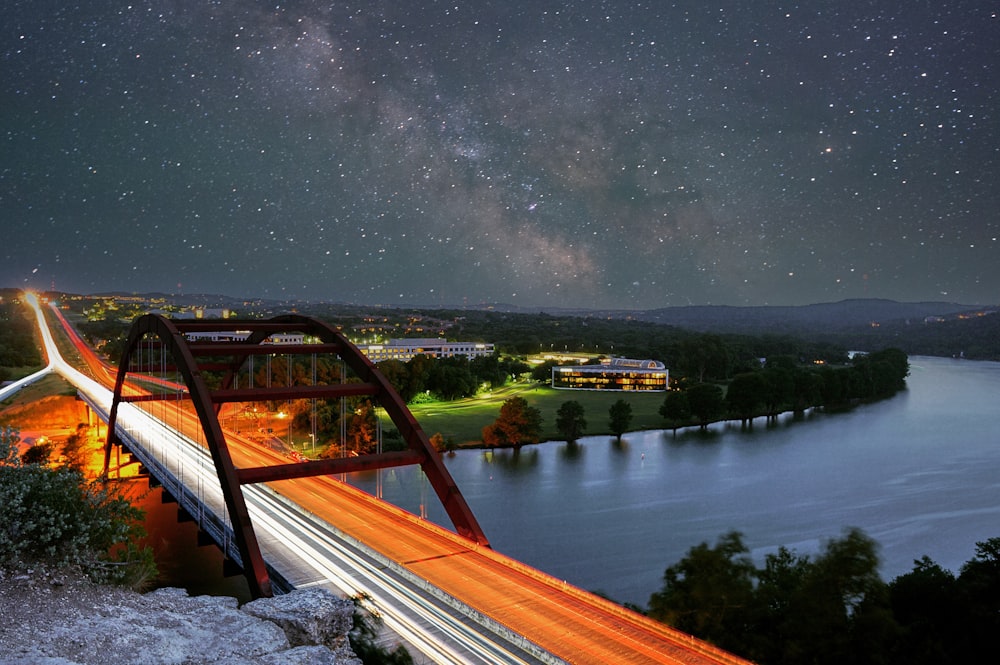 brown wooden bridge over river during night time