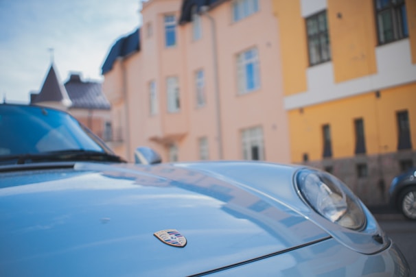 Close-up of a gleaming luxury car hood freshly detailed by autoluxx in a sunlit Dubai villa driveway.