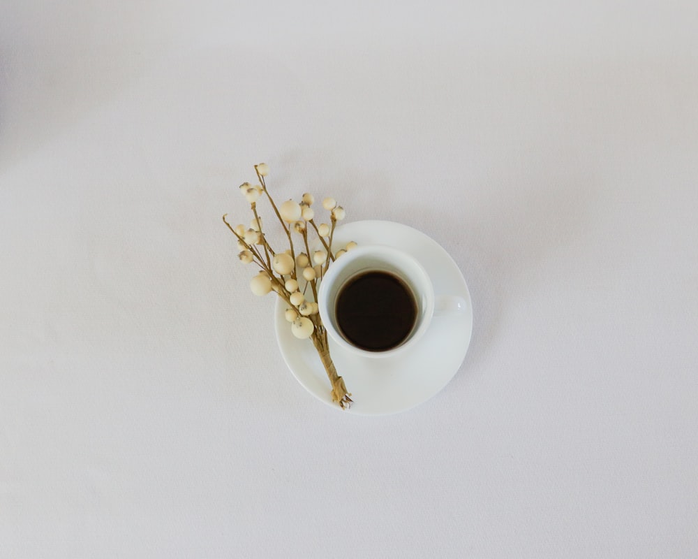 white ceramic mug on white saucer