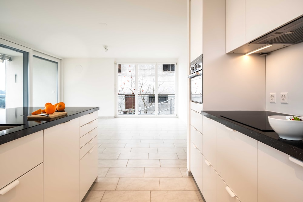 white wooden kitchen cabinet near black flat screen tv