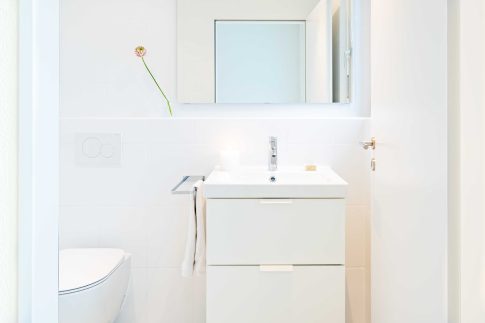 white ceramic sink beside white ceramic sink