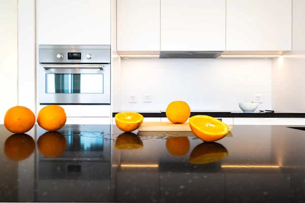 Kitchen with a polished dark stone countertop