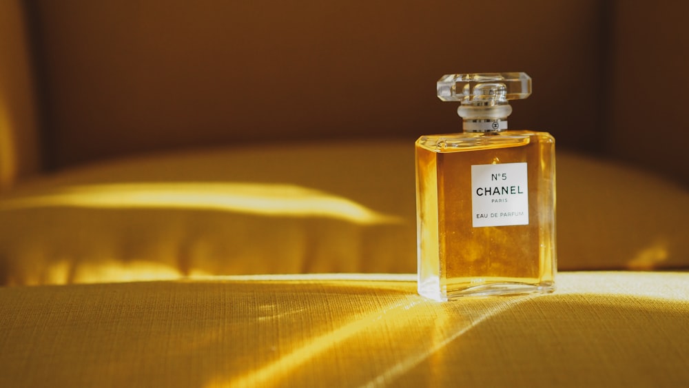 A bottle of perfume sitting on top of a table photo – Free Perfume