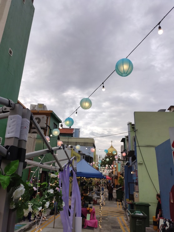 A lively street festival in Penang with colorful decorations and smiling locals.