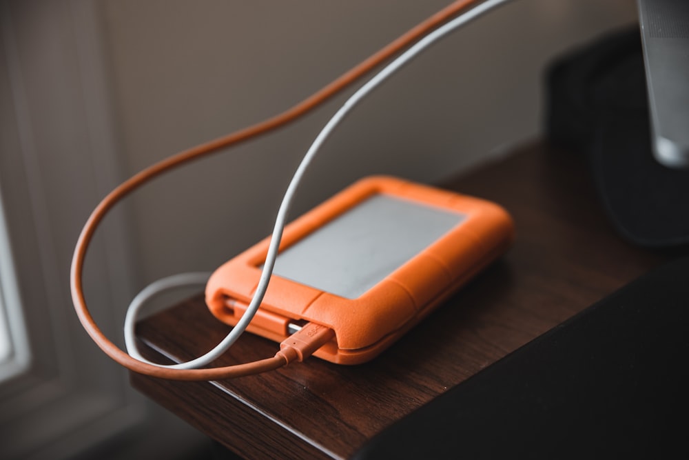 brown flip phone on brown wooden table