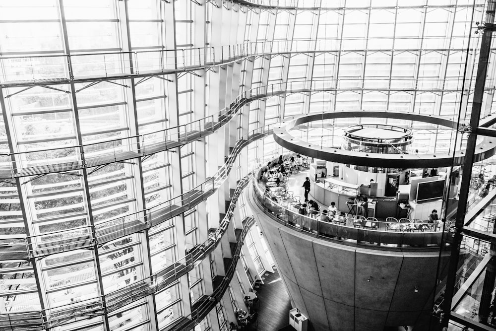 people walking inside building with glass walls