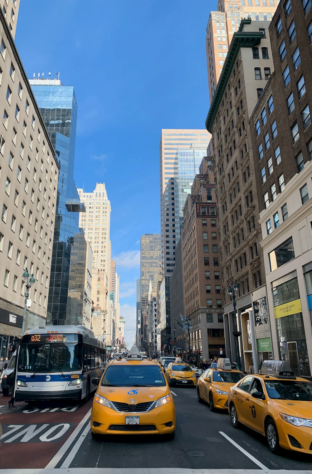 cars on road near high rise buildings during daytime