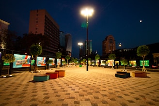 Night view of Gorriti Plaza with illuminated commercial spaces and pedestrian-friendly walkways.