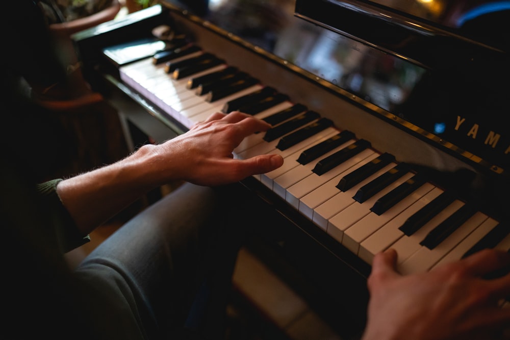 person playing piano inside room