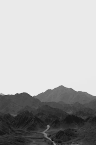black and white mountains under white sky