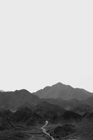 black and white mountains under white sky