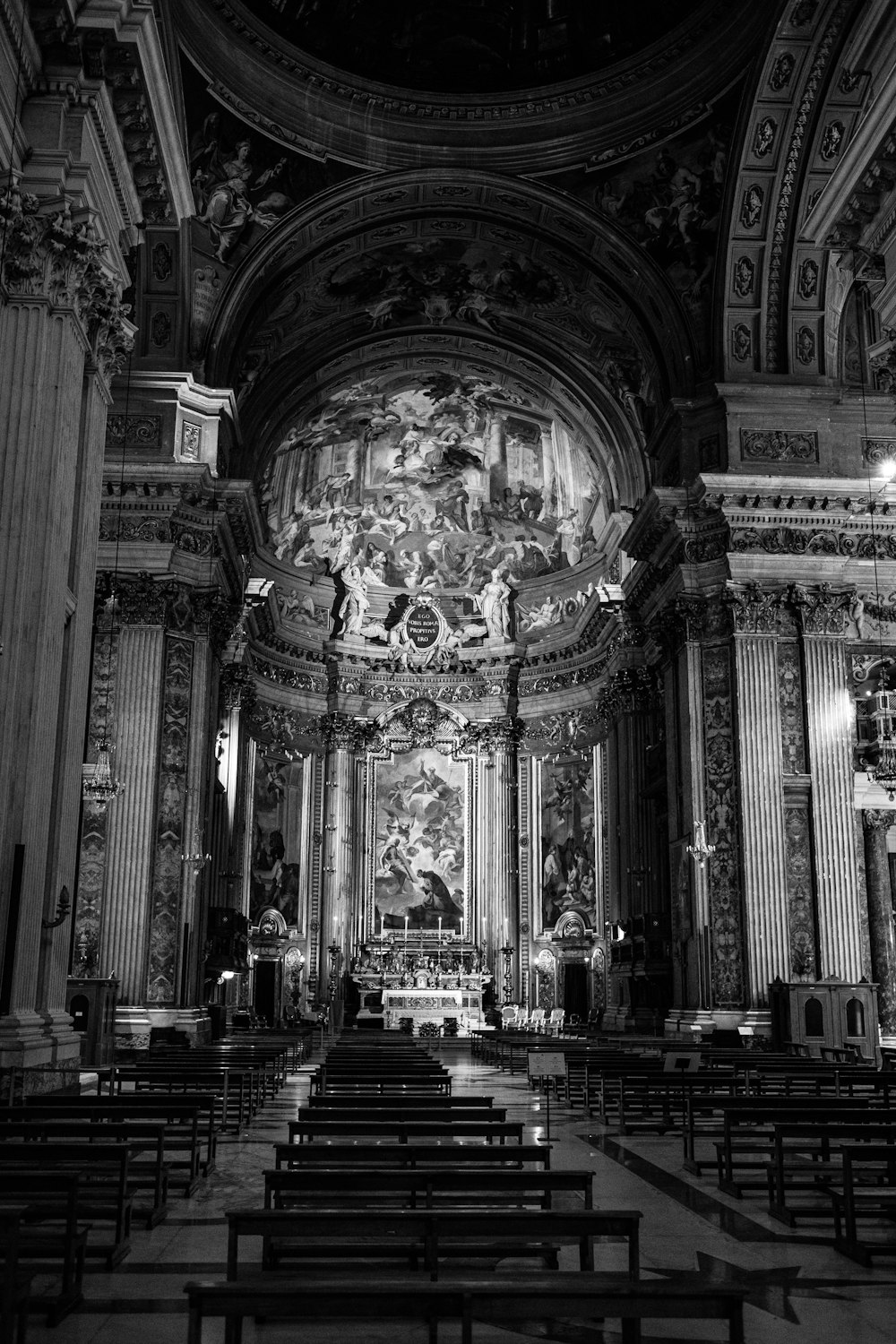 grayscale photo of people inside cathedral