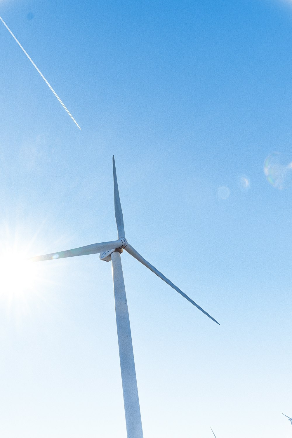 white windmill under blue sky during daytime