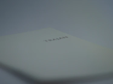 Close-up of an open TRAI book edition with digital innovation graphics overlay.