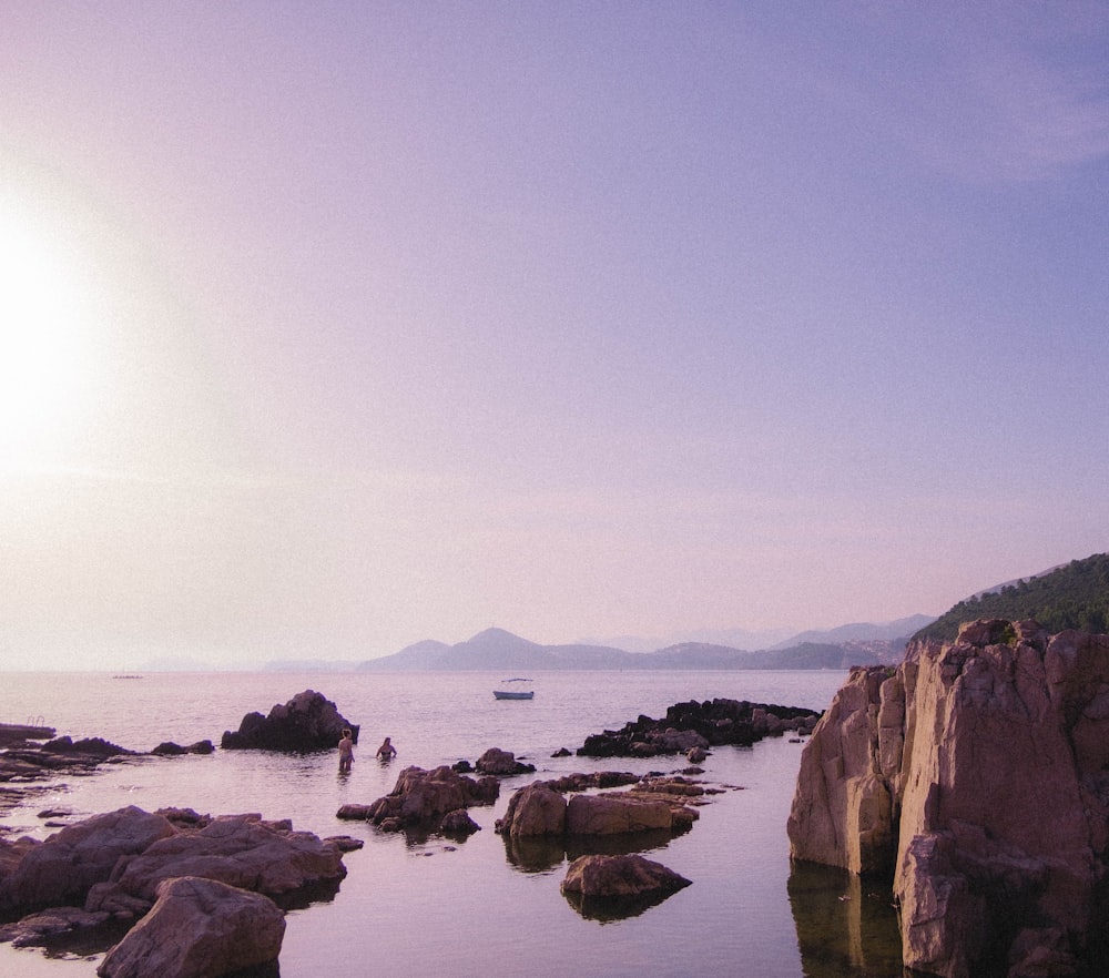 brown rock formation near body of water during daytime