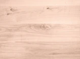 Maple wood surface with a smooth, creamy finish and subtle grain.