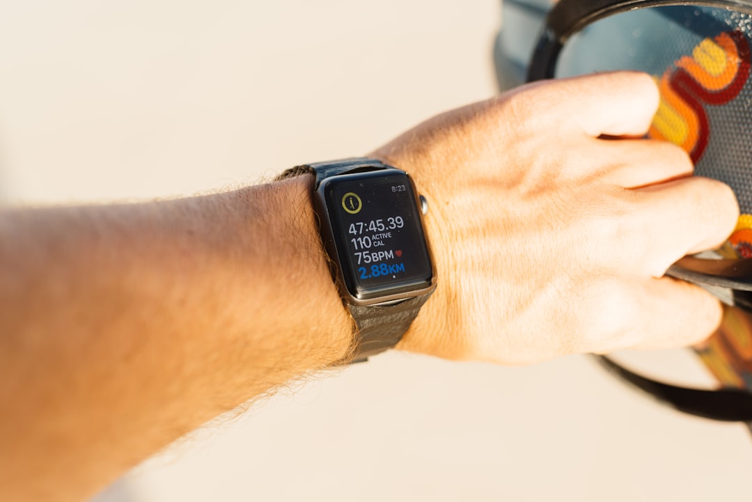 person wearing silver aluminum case apple watch with brown leather strap