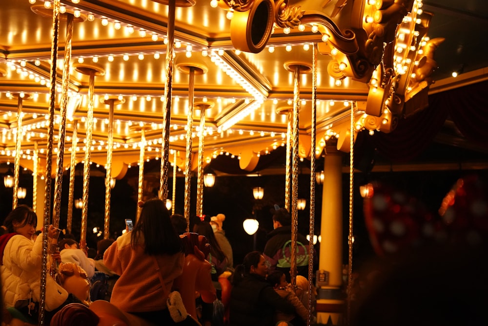 people riding on carousel during night time