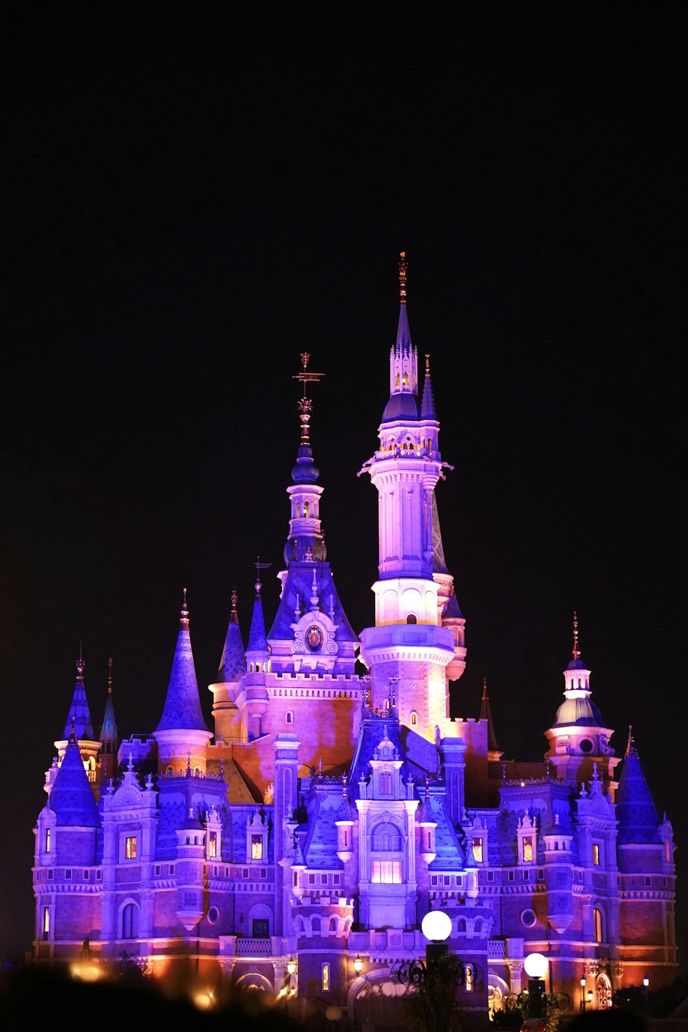 disney castle with lights during night time