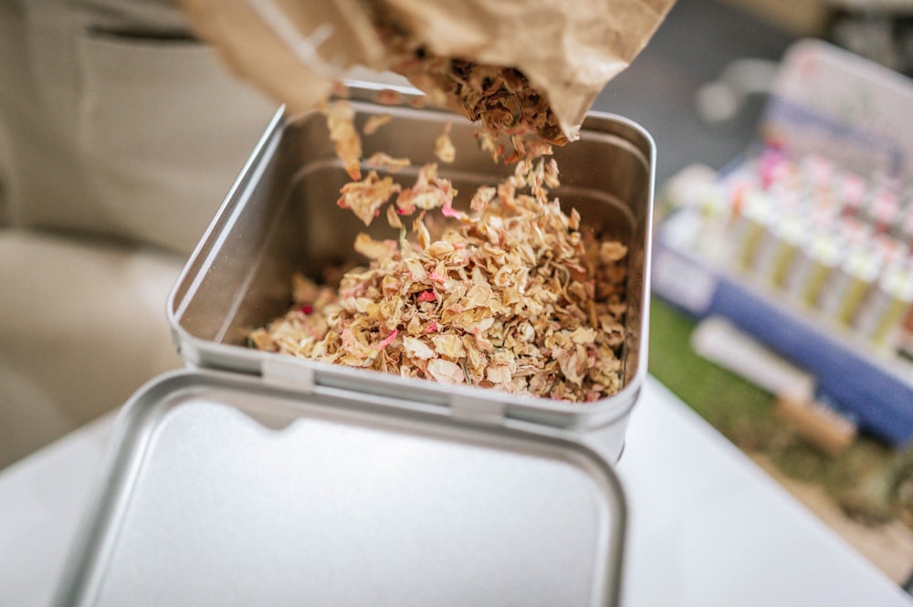 brown and white popcorn in white plastic container