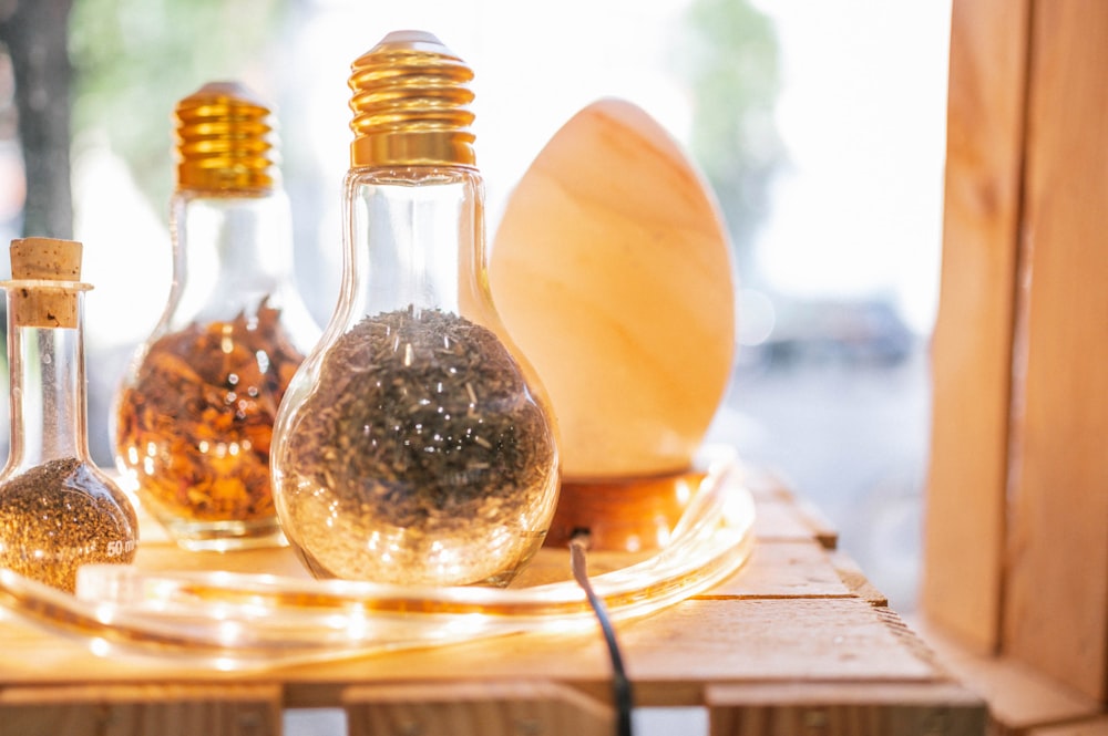 clear glass condiment shaker on brown wooden table